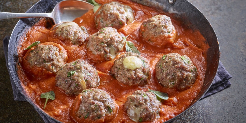 Comté-stuffed pork, beef and fennel meatballs in a tomato sauce
