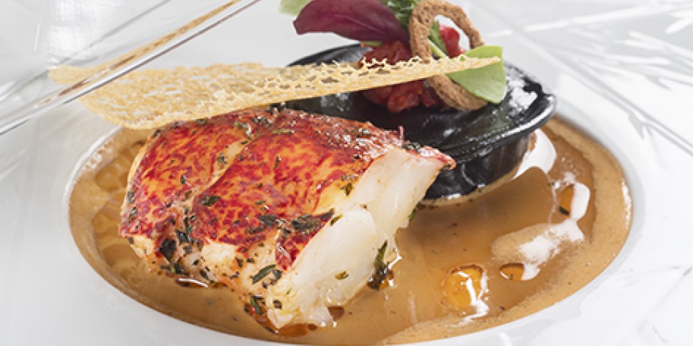 Lobster served hot and cold with lobster claw and squid ink ravioli