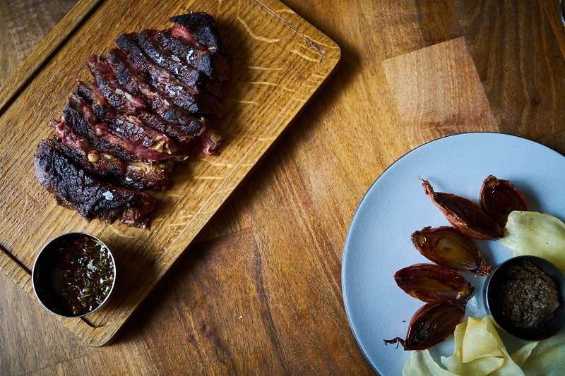 Perfectly cooked beef on a wooden board