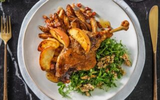 Duck leg confit with bacon potatoes and caramelised apples