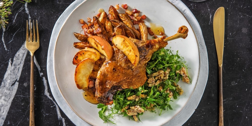 Duck leg confit with bacon potatoes and caramelised apples