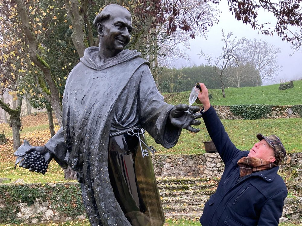 Dom Perignon statue with a man filling his glass