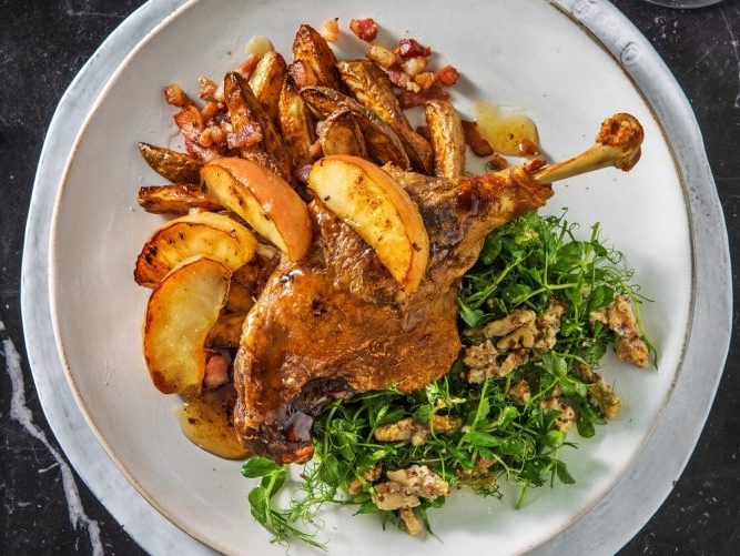 Duck leg confit with bacon potatoes and caramelised apples