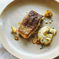Pan fried cod loin with white bean purée & garlic crisps