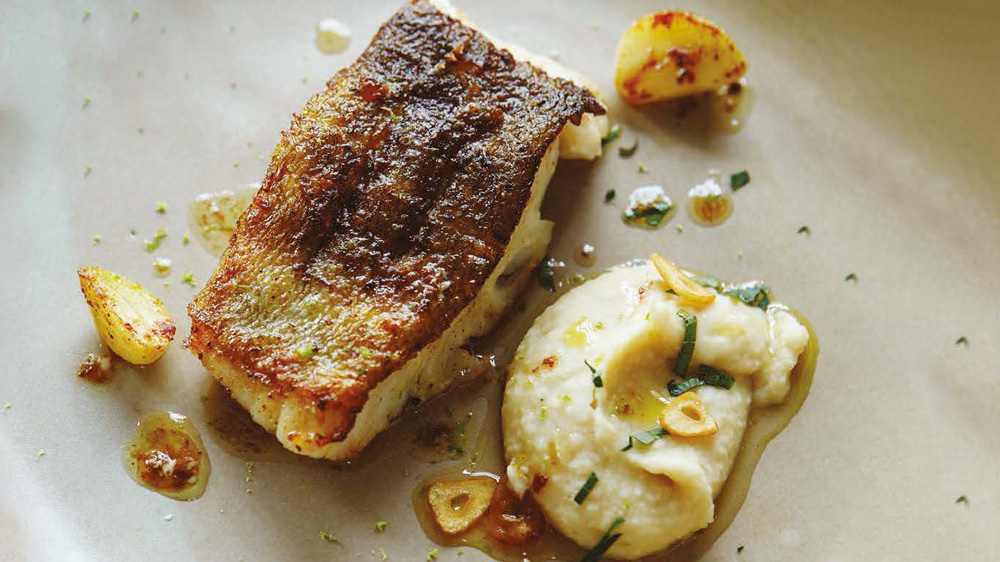 Pan fried cod loin with white bean purée & garlic crisps